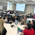 conference attendees participate in round table discussions
