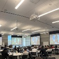 conference attendees listen to speaker