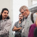 Poster presenter explaining poster to other attendees