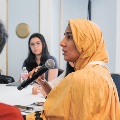 Speaker talks to attendees in crowd