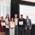 Dr. McLellan stands with trainee presentation and poster award winners