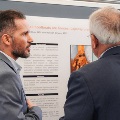 judge and attendee discuss poster presentation