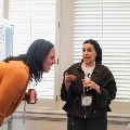 attendee and poster presenter discuss poster