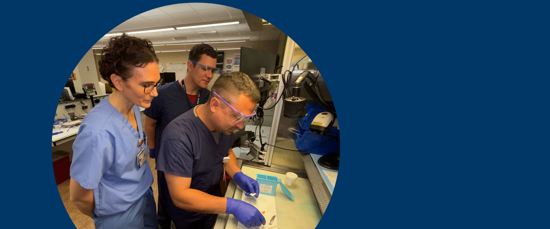 Dr. Michelle Felicella and two residents look at a study in the Surgical Pathology Frozen Section Lab.