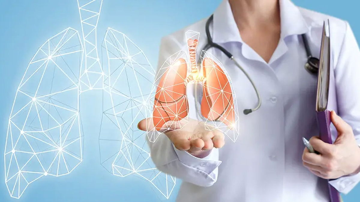 A doctor in a white coat with a graphic of lungs on a blue background
