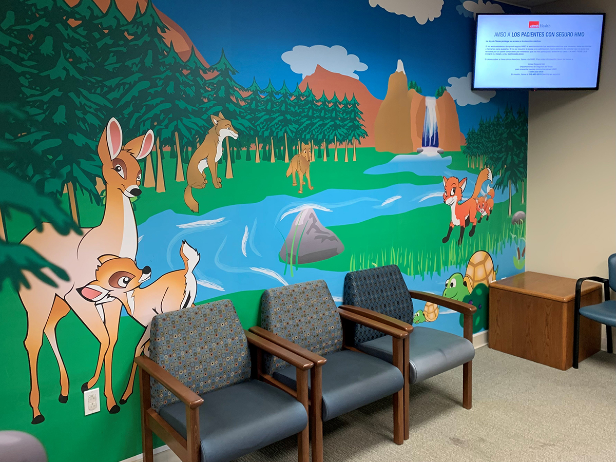 A waiting room with cartoon animal paintings on the wall.