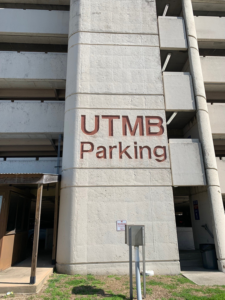 Side of a parking garage that reads UTMB Parking.
