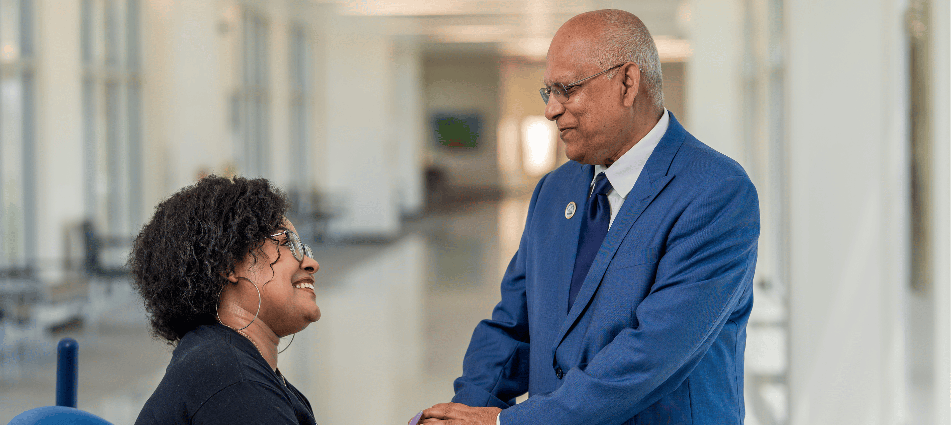 Yuniquie Robinson shakes hands with Dr. Abdul Khan in a hosptial hallway