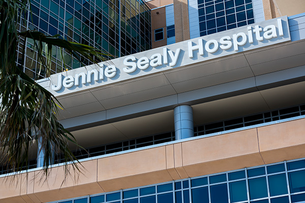 Jennie Sealy Hospital Sign Zoomed in shot of the Jennie Sealy Hospital sign outside of the building.