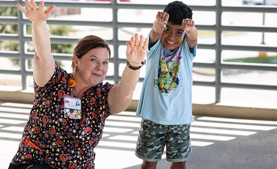 Left: Julie L. Hanson, UTMB Health nurse; Right: Jose Ruiz Juile and Jose hold up their hands in joy