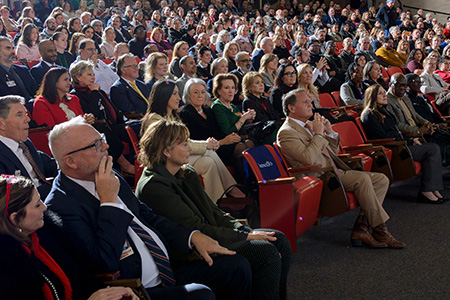 Logo Launch Audience Audience members seated in a packed auditorium, attentively watching a presentation during the UTMB logo launch event.