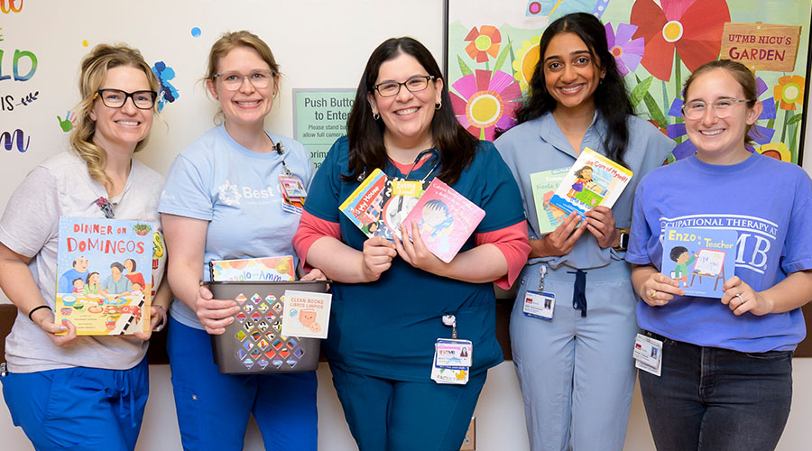 From left, occupational therapists Shawna Ocaranza and Allison Migliore, Dr. Maria Franco Fuenmayor, Nidhi Subramanian, medical student, and Daniella Edwards, occupational therapy student, display books donated by SMART Family Literacy. Shawna Ocaranza and Allison Migliore, Dr. Maria Franco Fuenmayor, Nidhi Subramanian, medical student, and Daniella Edwards, occupational therapy student, display books donated by SMART Family Literacy.