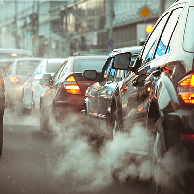 Polution Exhaust fumes coming from vehicles in stand-still traffic.