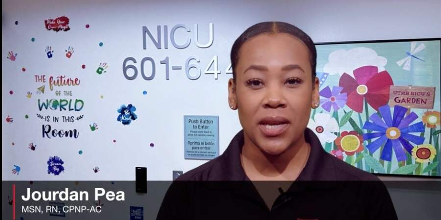 A person stands in front of a NICU hallway wall decorated with colorful graphics and text, including ‘The future of the world is in this room,’ with the name ‘Jourdan Pea, MSN, RN, CPNP‑AC’ displayed at the bottom.
