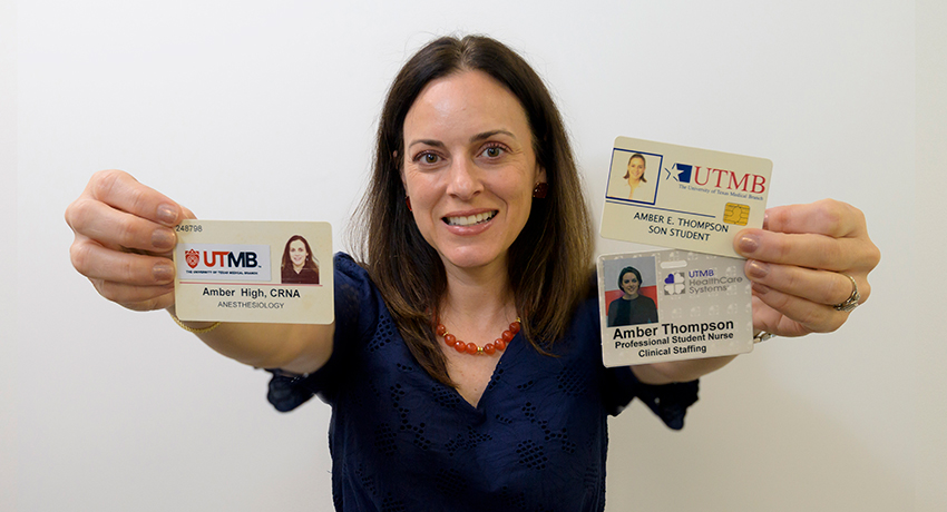A woman in a blue top holds three UTMB badges in front of her.