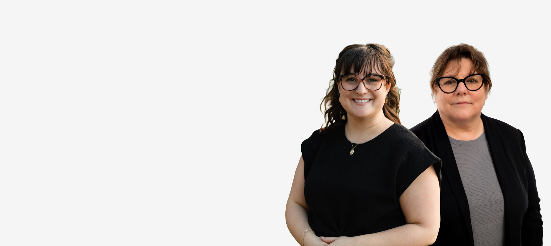 Two women wearing glasses and dressed in black appear in professional headshots.