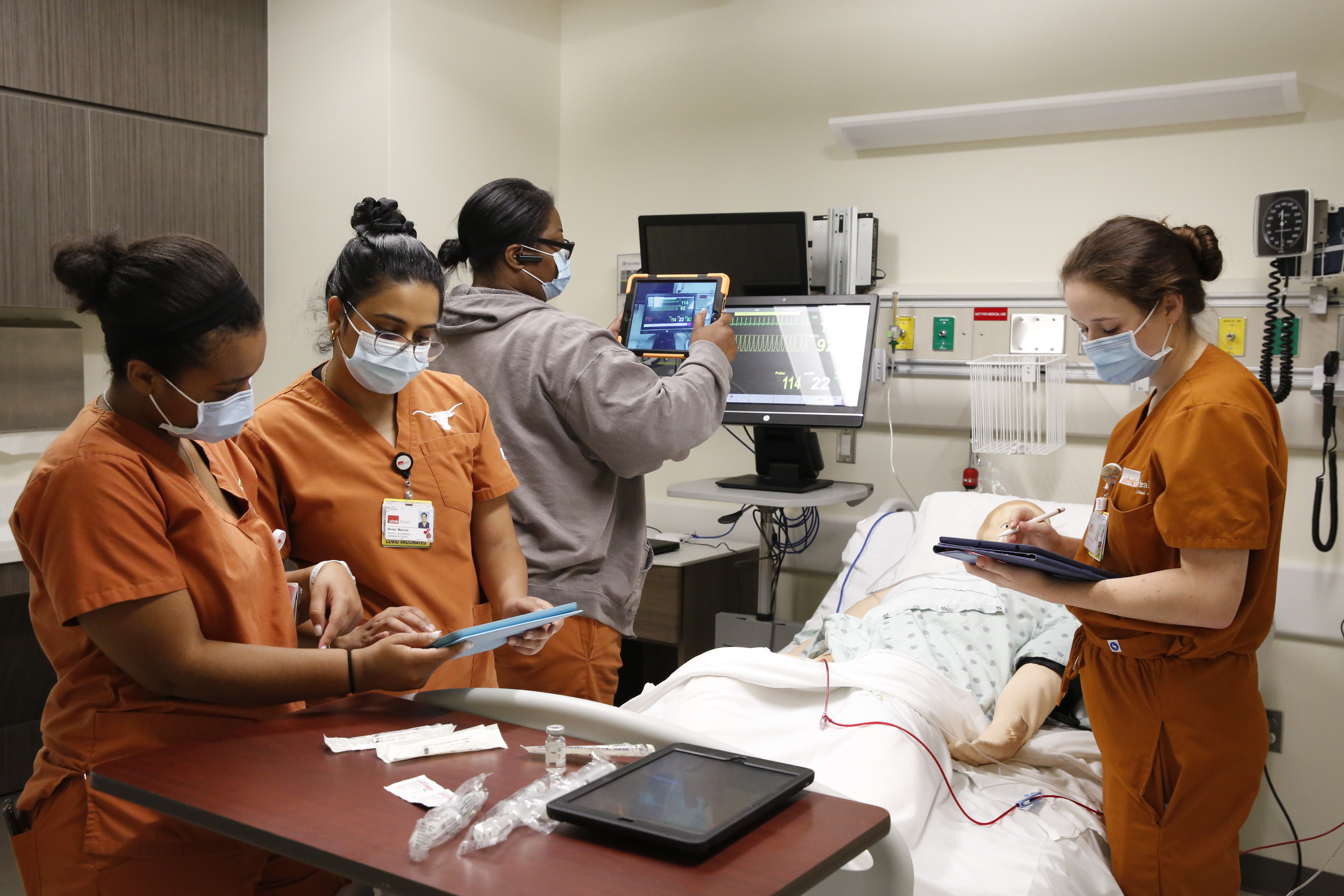 school of Nursing students working with a mock patient