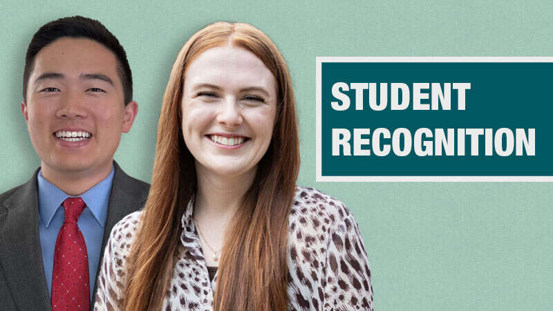 Two people stand in front of a teal background beside a box displaying the words "Student Recognition."