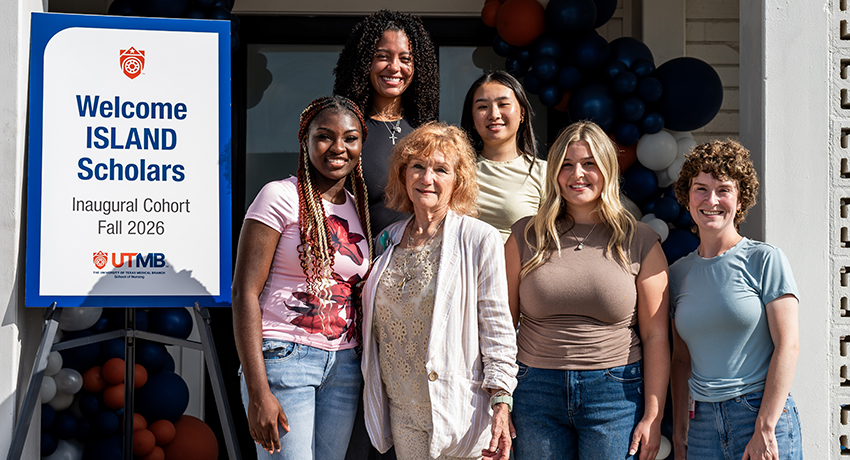 Five students and two UTMB staff members gather by a sign reading "Island Scholars Inaugural Cohort Fall 2026."