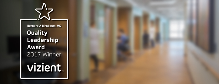 Graphic featuring the Vizient Bernard A. Birnbaum, MD, Quality Leadership Award 2017 Winner badge next to a softly blurred hospital hallway interior.