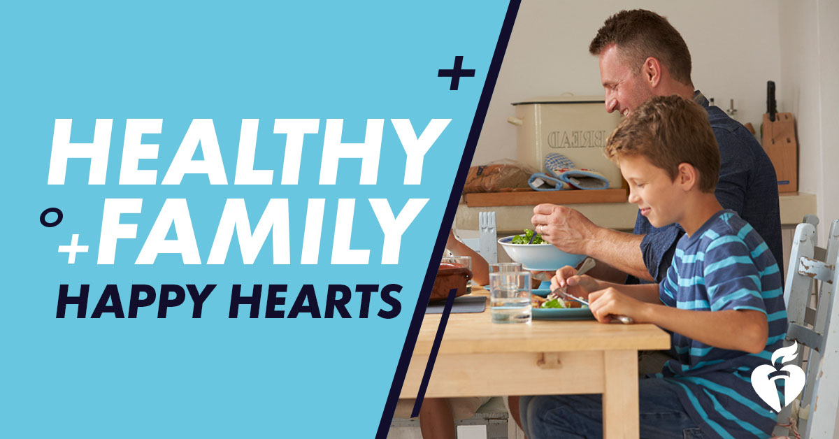 Father and child sit at a kitchen table eating a healthy meal, alongside graphic text reading “Healthy family, happy hearts”