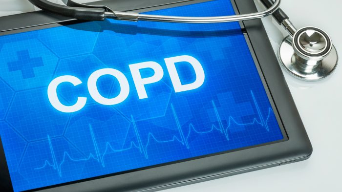 Digital tablet with white COPD letters on blue background and stethoscope partially draped across the top right and side